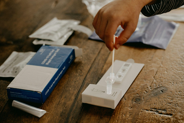 Travel policies need to be updated to provide clear guidance as to what workplace travellers should do if they test positive for COVID before or during their trip.